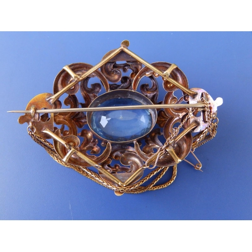 201 - A large Victorian aquamarine set brooch, of oval open scroll form, set with a large faceted oval aqu... 