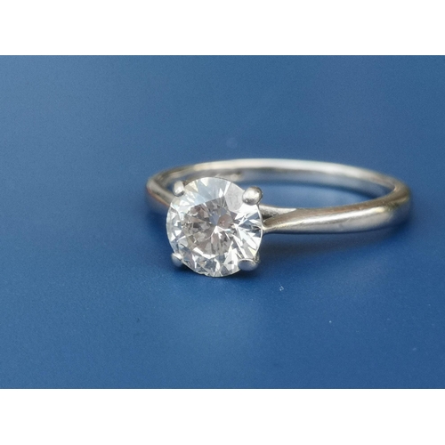 208 - A diamond solitaire ring, the four claw set brilliant weighing approximately one carat, on platinum ... 