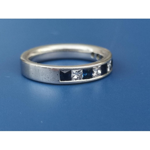 209 - A sapphire & diamond calibre set platinum half eternity ring.  Finger size M.