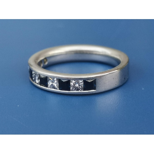 209 - A sapphire & diamond calibre set platinum half eternity ring.  Finger size M.