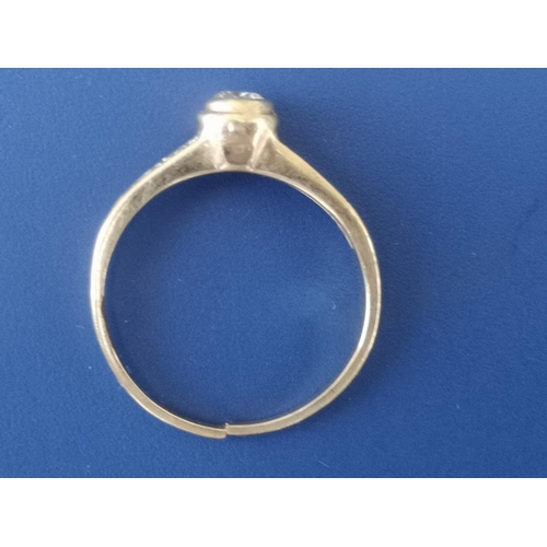 213 - A small collet set diamond solitaire ring with diamond shoulders - shank cut.  Finger size L.