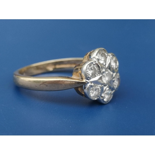 221 - A 9ct gold diamond daisy cluster ring.  Finger size K/L.