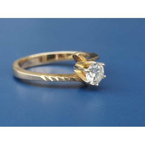 222 - A modern crossover set diamond solitaire, the claw set brilliant weighing approximately 0.50 carat. ... 