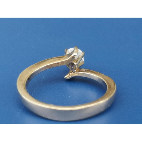 222 - A modern crossover set diamond solitaire, the claw set brilliant weighing approximately 0.50 carat. ... 