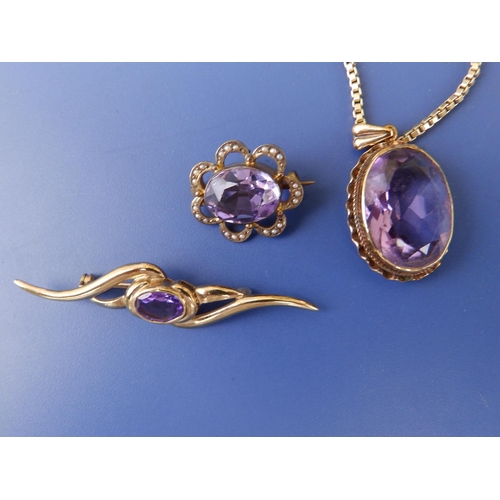 232 - An oval amethyst pendant on 9c box link necklace chain and two amethyst brooches. (3)