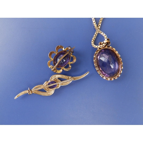 232 - An oval amethyst pendant on 9c box link necklace chain and two amethyst brooches. (3)