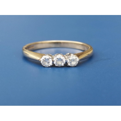 233 - A small three stone diamond set 9ct gold ring. Finger size P.