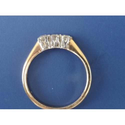 233 - A small three stone diamond set 9ct gold ring. Finger size P.