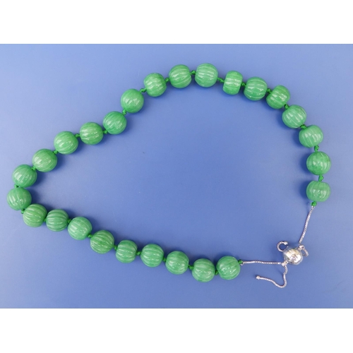 238 - A carved jade bead necklace with 925 spherical clasp,  21