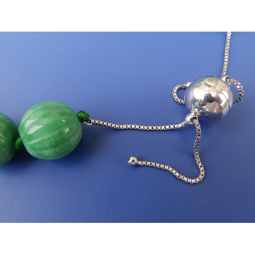 238 - A carved jade bead necklace with 925 spherical clasp,  21