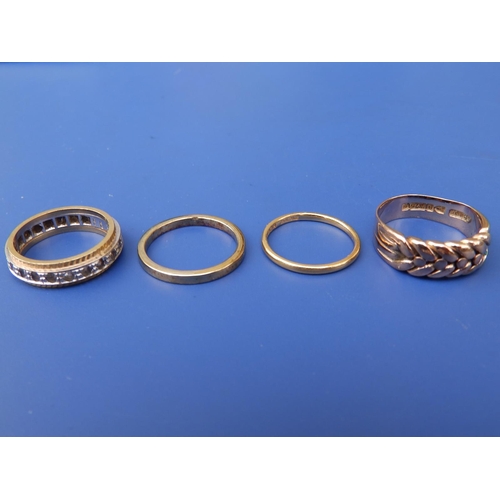 239 - A small 22ct wedding ring, finger size K, an 18ct band and two other rings. (4)