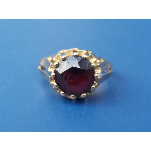 240 - An 18ct gold solitaire ring set with a red paste stone, London import marks.  Finger size M