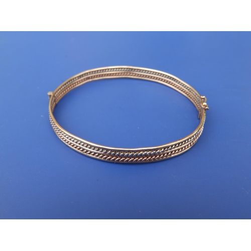 243 - Two-colour yellow metal bangle, maximum diameter 2.4