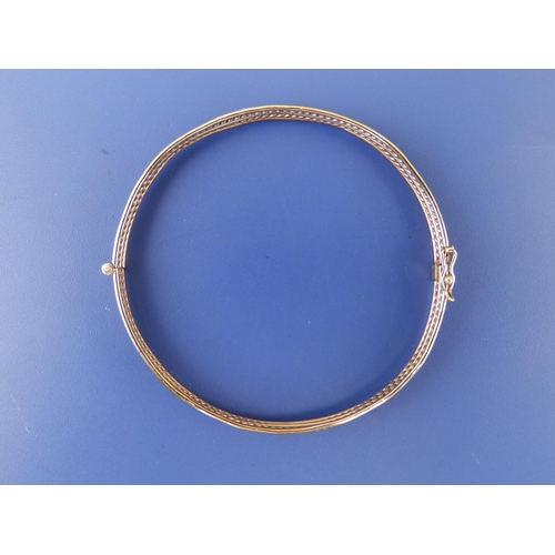 243 - Two-colour yellow metal bangle, maximum diameter 2.4