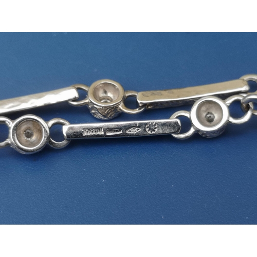 246 - A diamond set 18ct white gold bracelet by Torrini, having foliate engraved decoration to the links, ... 