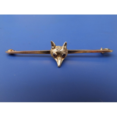 247 - A 9c fox head set bar brooch with ruby/garnet eyes, 2.5