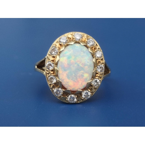 248 - An opal & diamond oval cluster ring on 18ct shank.  Finger size K/L.