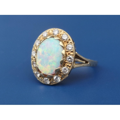 248 - An opal & diamond oval cluster ring on 18ct shank.  Finger size K/L.