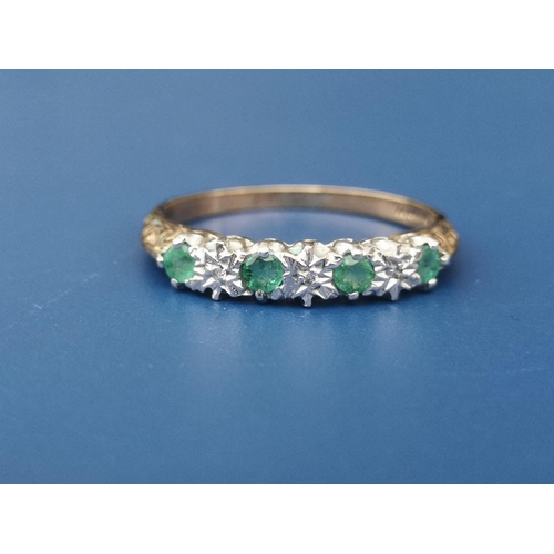 251 - An emerald & diamond illusion set 9ct gold ring.  Finger size O.