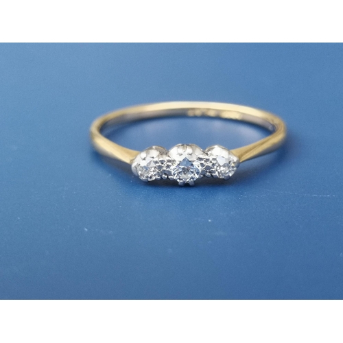 255 - A small diamond three stone ring - '18ct' & 'PLAT'.  Finger size Q.