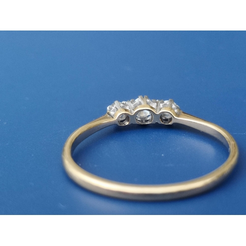 255 - A small diamond three stone ring - '18ct' & 'PLAT'.  Finger size Q.