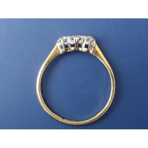 255 - A small diamond three stone ring - '18ct' & 'PLAT'.  Finger size Q.