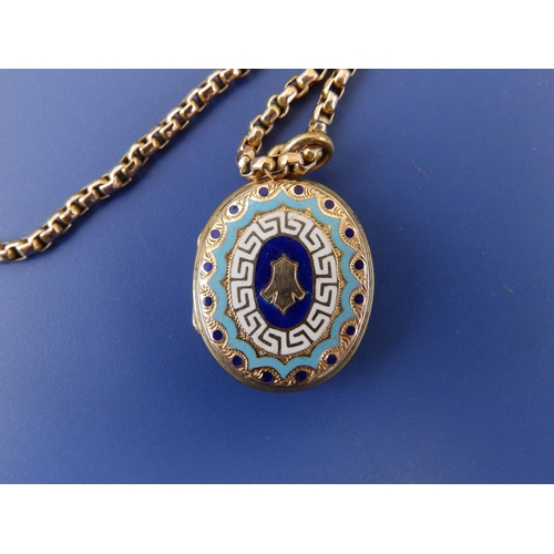 256 - An enamelled yellow metal oval locket on 9ct chain, the locket , 1