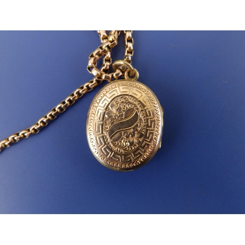 256 - An enamelled yellow metal oval locket on 9ct chain, the locket , 1