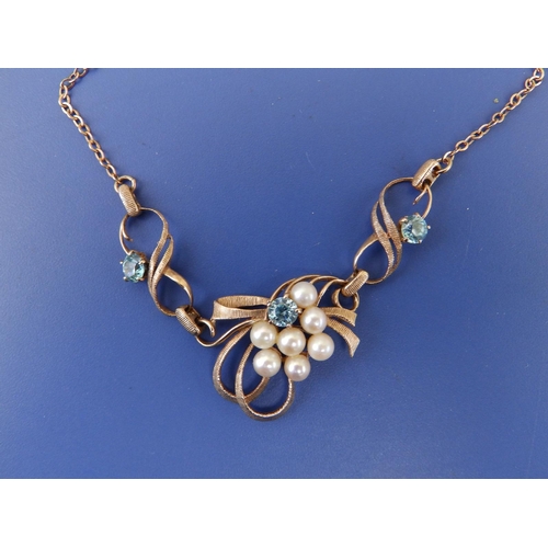 257 - A 9ct gold pendant necklace set with pearls and pale blue stones.