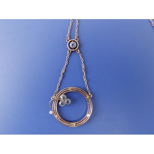 258 - A 9c pendant necklace, of open circular form with seed pearls.