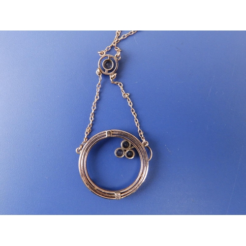 258 - A 9c pendant necklace, of open circular form with seed pearls.