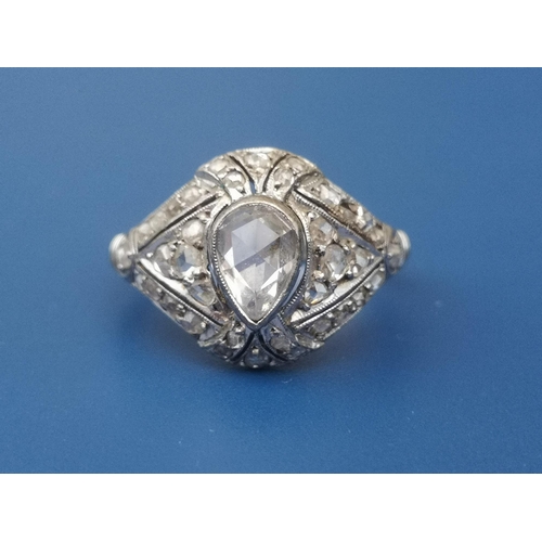 283 - A boxed Egyptian rose cut diamond cocktail ring, a central pear shaped stone surrounded by numerous ... 