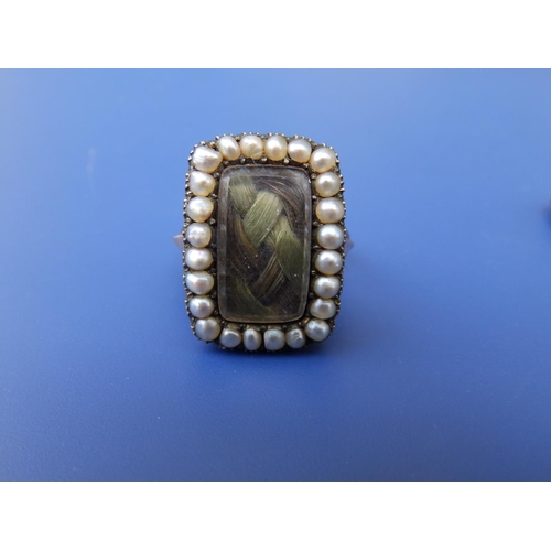 285 - A 19thC memorial ring, the rectangular glazed panel inset with plaited hair within a border of seed ... 