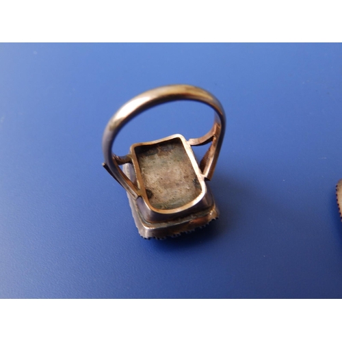 285 - A 19thC memorial ring, the rectangular glazed panel inset with plaited hair within a border of seed ... 