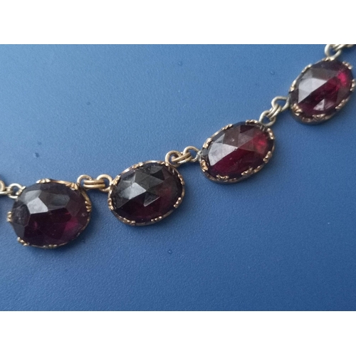 288 - A 19thC graduated garnet set riviere necklace, the faceted oval stones held in crown-shaped claws, 1... 