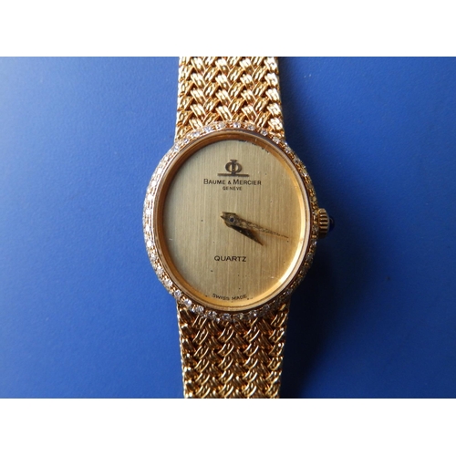 314 - A lady's diamond set 18ct gold Baume & Mercier Quartz bracelet wrist watch with oval gold dial, sapp... 