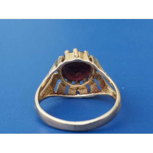 240 - An 18ct gold solitaire ring set with a red paste stone, London import marks.  Finger size M