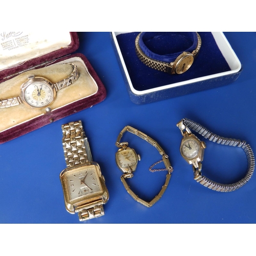 292 - A boxed lady's Garrard gold presentation wrist watch on plated strap, two other ladies' gold watches... 