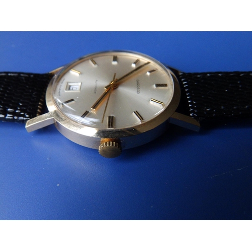 299 - A gent's gold Garrard Automatic presentation wrist watch with silvered dial, date indicator, gold ba... 