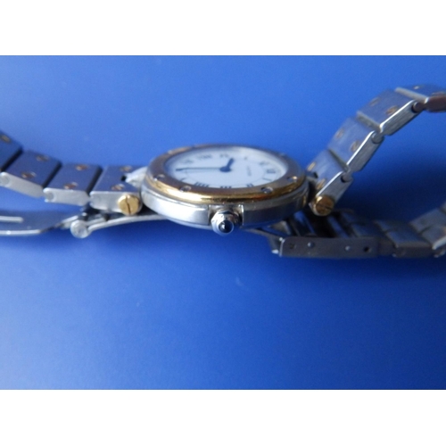 304 - A lady's bi-metal Santos de Cartier quartz bracelet wrist watch, case diameter 28mm.