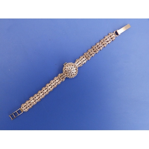 323 - A lady's 9ct gold 'Helvetia' bracelet wrist watch with concealed dial.