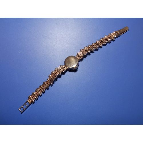 323 - A lady's 9ct gold 'Helvetia' bracelet wrist watch with concealed dial.