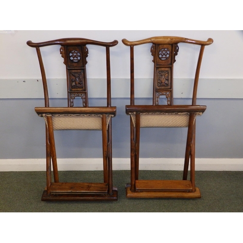 47 - A pair of Chinese folding chairs, having carved splats and footrests, Height 38