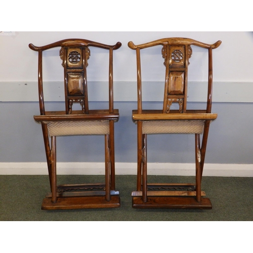 47 - A pair of Chinese folding chairs, having carved splats and footrests, Height 38