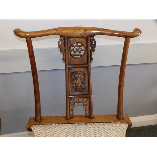 47 - A pair of Chinese folding chairs, having carved splats and footrests, Height 38