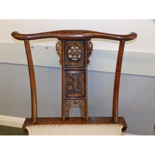 47 - A pair of Chinese folding chairs, having carved splats and footrests, Height 38