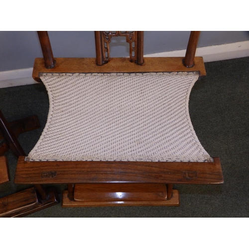 47 - A pair of Chinese folding chairs, having carved splats and footrests, Height 38