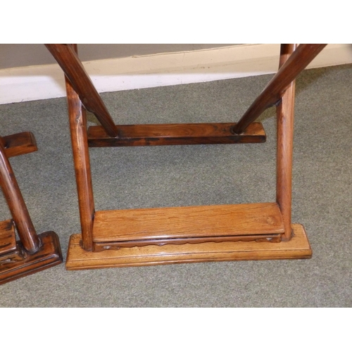 47 - A pair of Chinese folding chairs, having carved splats and footrests, Height 38