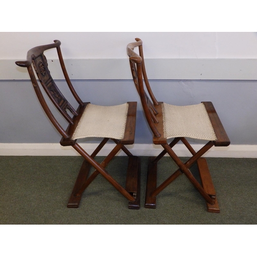47 - A pair of Chinese folding chairs, having carved splats and footrests, Height 38
