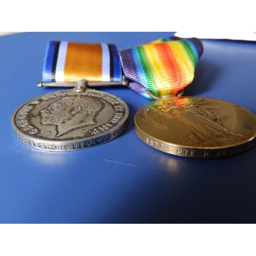 56 - A WWI medal pair awarded to 38703 Pte. H. Webber, Devon Regiment. (2)